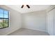 Bright bedroom with large window, ceiling fan, and neutral walls at 17923 Polo Trl, Bradenton, FL 34211