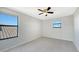 Well-lit bedroom featuring two windows and ceiling fan at 17923 Polo Trl, Bradenton, FL 34211