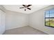 Simple bedroom with neutral decor and a window at 17923 Polo Trl, Bradenton, FL 34211