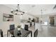 Modern dining area with glass table and black chairs near kitchen at 17923 Polo Trl, Bradenton, FL 34211