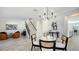 Open concept dining area with a glass-top table and view into the kitchen at 17923 Polo Trl, Bradenton, FL 34211