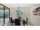 Breakfast nook with glass table, black chairs, and pool view at 17923 Polo Trl, Bradenton, FL 34211