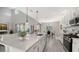 Modern kitchen with white cabinets, island, and open layout at 17923 Polo Trl, Bradenton, FL 34211