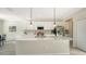 Modern kitchen with white cabinets, stainless steel appliances and an island at 17923 Polo Trl, Bradenton, FL 34211