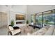 Spacious living room with a fireplace, large windows, and pool view at 17923 Polo Trl, Bradenton, FL 34211