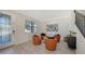 Bright living room showcasing a modern seating arrangement, decorative painting, and a staircase with rod iron railing at 17923 Polo Trl, Bradenton, FL 34211