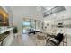 Two-story living room with a fireplace and access to the pool area at 17923 Polo Trl, Bradenton, FL 34211