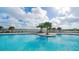 Resort-style pool with palm trees and lounge chairs at 17923 Polo Trl, Bradenton, FL 34211
