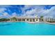 Inviting community pool with surrounding lounge chairs at 17923 Polo Trl, Bradenton, FL 34211