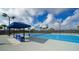 Tennis court with shaded seating area at 17923 Polo Trl, Bradenton, FL 34211