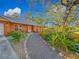 Welcoming walkway to charming house with landscaped yard at 2030 Faun Rd, Venice, FL 34293