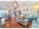 Bright living room with hardwood floors, open floor plan, and view into kitchen at 2030 Faun Rd, Venice, FL 34293