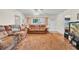 Living room with hardwood floors and brown sofas at 204 80Th N Ave, St Petersburg, FL 33702