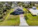 Single-story house with a driveway and surrounding landscape at 2179 W Price Blvd, North Port, FL 34286