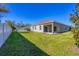 Home with grassy backyard and fence at 2179 W Price Blvd, North Port, FL 34286
