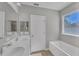 Bathroom with double vanity and garden tub at 2179 W Price Blvd, North Port, FL 34286