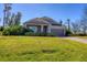 One-story home with gray siding, stone accents, and a two-car garage at 2179 W Price Blvd 2179 W Price Blvd, North Port, FL 34286