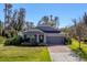 Gray one-story house with a brick paved driveway and landscaping at 2179 W Price Blvd, North Port, FL 34286