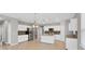 Modern kitchen with white cabinets, granite countertops, and stainless steel appliances at 2179 W Price Blvd, North Port, FL 34286