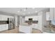 Modern kitchen with white cabinets, granite countertops, and stainless steel appliances at 2179 W Price Blvd, North Port, FL 34286