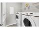 Laundry room with washer, dryer, and shelving at 2179 W Price Blvd, North Port, FL 34286