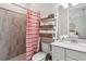 Bathroom with a shower, striped curtain, and white vanity at 25119 Spartina Dr, Venice, FL 34293