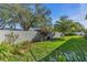 Landscaped backyard with lush lawn and privacy wall at 2586 Prospect St, Sarasota, FL 34239