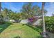 Landscaped backyard with green lawn and privacy wall at 2586 Prospect St, Sarasota, FL 34239