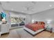 Bright bedroom with a large window, light wood floors, and modern decor at 2586 Prospect St, Sarasota, FL 34239