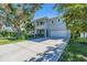 Contemporary two-story home with a large driveway, attached two-car garage, and manicured lawn at 2586 Prospect St, Sarasota, FL 34239