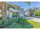 Modern two-story home with a gray facade, balcony, manicured lawn, and an attached two-car garage at 2586 Prospect St, Sarasota, FL 34239