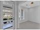 Bright foyer with modern door, white trim, tile flooring, and view to front yard at 2586 Prospect St, Sarasota, FL 34239
