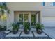 Modern home's front entrance with landscaping and three large pots at 2586 Prospect St, Sarasota, FL 34239