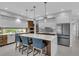 Modern kitchen boasts white cabinets, stainless steel appliances, and a large island with seating at 2586 Prospect St, Sarasota, FL 34239