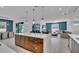 Open-concept kitchen with island seating connects seamlessly to the dining and living areas at 2586 Prospect St, Sarasota, FL 34239