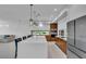 Spacious kitchen featuring white cabinets, wood accents, and stainless steel refrigerator at 2586 Prospect St, Sarasota, FL 34239