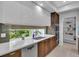 Kitchen with sleek cabinets, modern appliances, quartz countertops, and view of lush landscaping at 2586 Prospect St, Sarasota, FL 34239