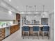 Open-concept kitchen featuring a large island, stainless steel appliances, and modern pendant lighting at 2586 Prospect St, Sarasota, FL 34239