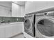 Laundry room with new appliances and a white countertop and cabinetry at 2586 Prospect St, Sarasota, FL 34239