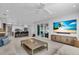 Open-concept living room with a large TV, modern furniture, and a view of the patio at 2586 Prospect St, Sarasota, FL 34239