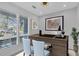 Home office featuring a large window with shutters, desk, artwork, and neutral decor at 2586 Prospect St, Sarasota, FL 34239