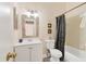 Simple bathroom with a bathtub, white vanity, and a black shower curtain at 2917 Park Lake Dr # 2917, Bradenton, FL 34209