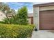 Neat landscaping leads to a brown double-door garage at 2917 Park Lake Dr # 2917, Bradenton, FL 34209