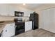 Modern kitchen with white cabinets and black appliances at 2917 Park Lake Dr # 2917, Bradenton, FL 34209