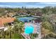 Community pool and tennis courts with surrounding landscaping and seating areas at 2917 Park Lake Dr # 2917, Bradenton, FL 34209