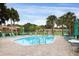 Relaxing community pool with lounge chairs and surrounding palm trees at 2917 Park Lake Dr # 2917, Bradenton, FL 34209
