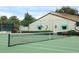 Green tennis court with net and surrounding fence at 2917 Park Lake Dr # 2917, Bradenton, FL 34209