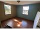 Bright bedroom with light brown hardwood floors and teal accent wall at 3006 N Oriente Ave, Sarasota, FL 34235