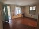 Simple living room with hardwood floors and a teal door at 3006 N Oriente Ave, Sarasota, FL 34235