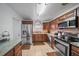 Modern kitchen with stainless steel appliances and wood cabinets at 3037 Alta Vista St, Sarasota, FL 34237